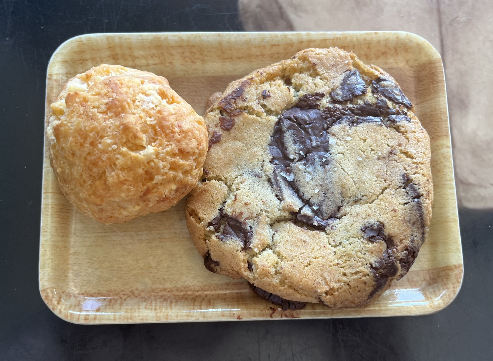 A chocolate chip cookie and cheesy pow bread on a rectangular plate